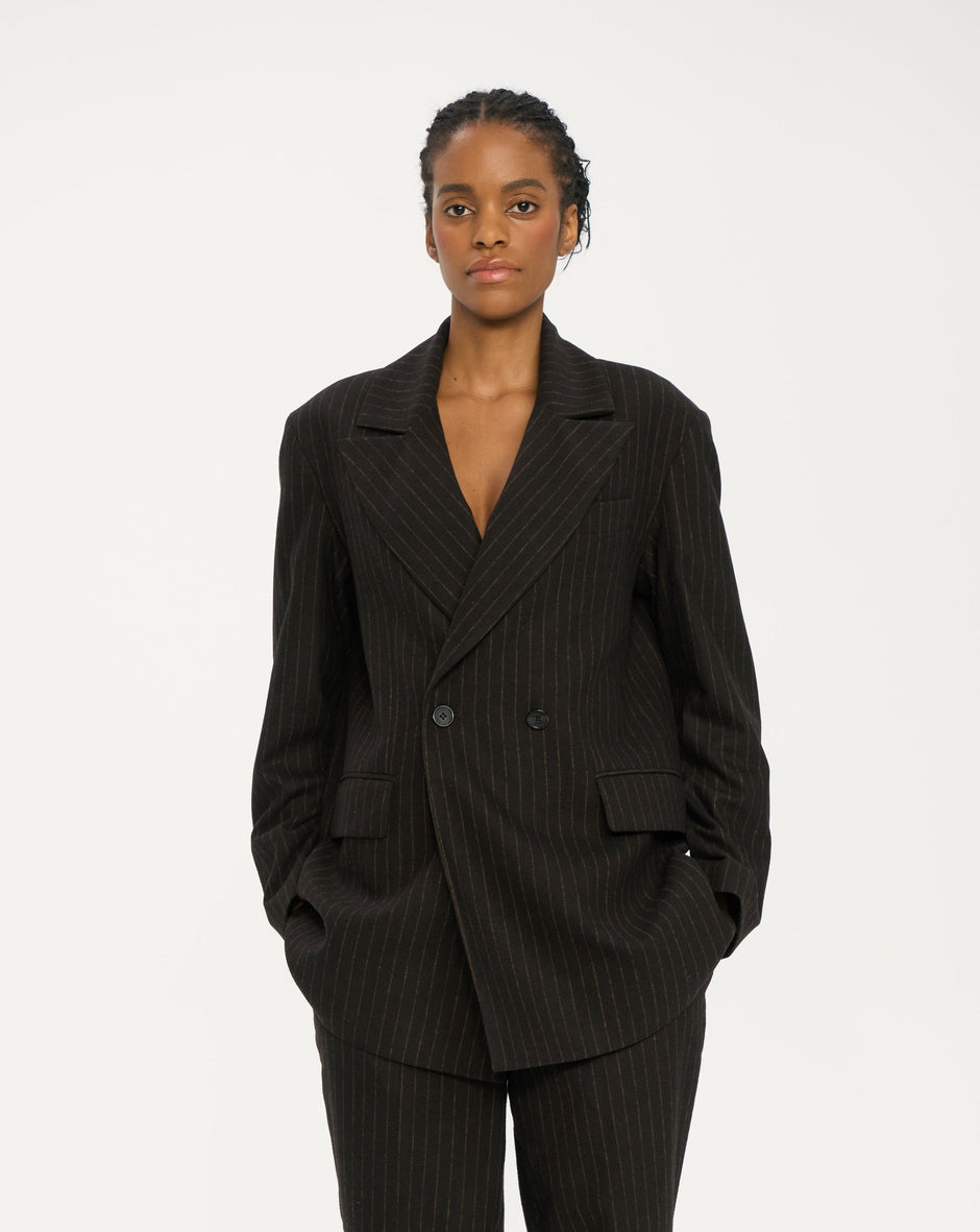 Chocolate pinstripe double-breasted blazer with longline silhouette and structured shoulders on model – Inner Tiger