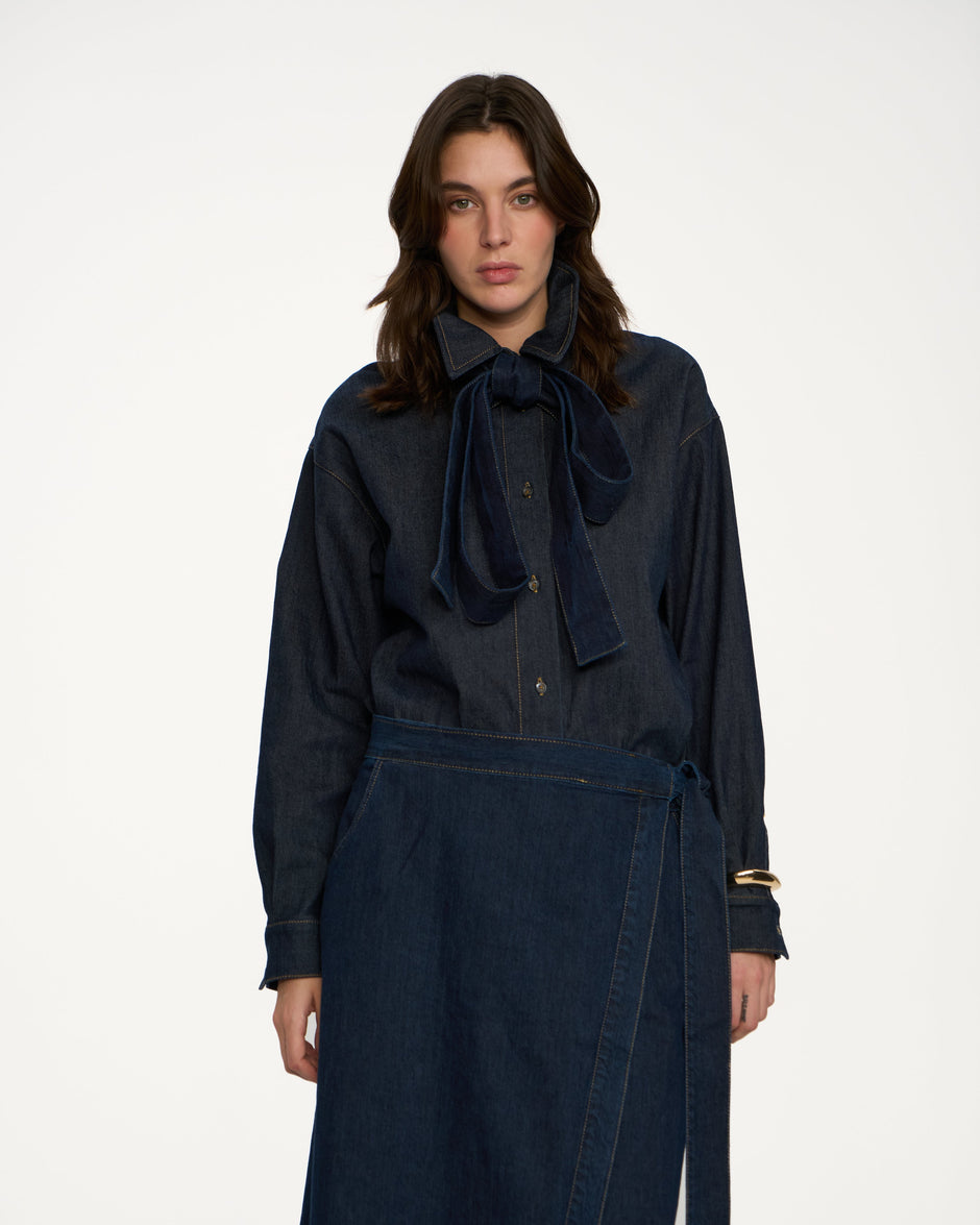 Indigo Italian denim bow overshirt with detachable neck tie, styled with matching wrap denim skirt, front view on model – Inner Tiger