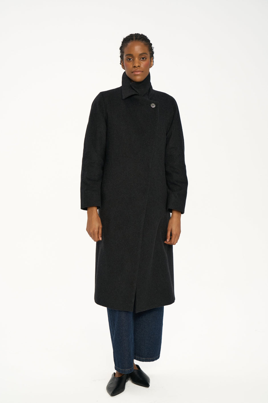 Model wearing dark charcoal cashmere coat with strong lapels, light blue shirt and dark indigo denim, minimalist styling – Inner Tiger