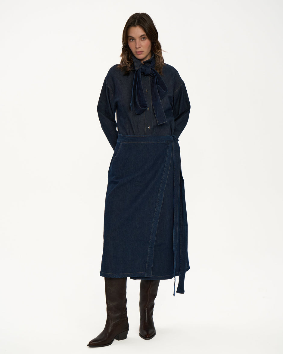 Front view of indigo denim overshirt with large bow at the collar and relaxed shoulders on model – Inner Tiger