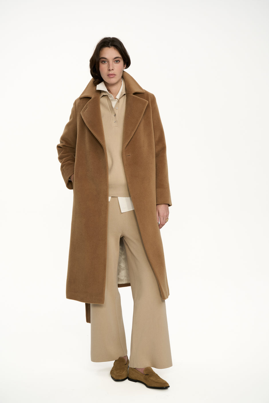 Camel wool wrap coat with belt styled over beige knit wide-leg trousers and loafers, full length front view – Inner Tiger