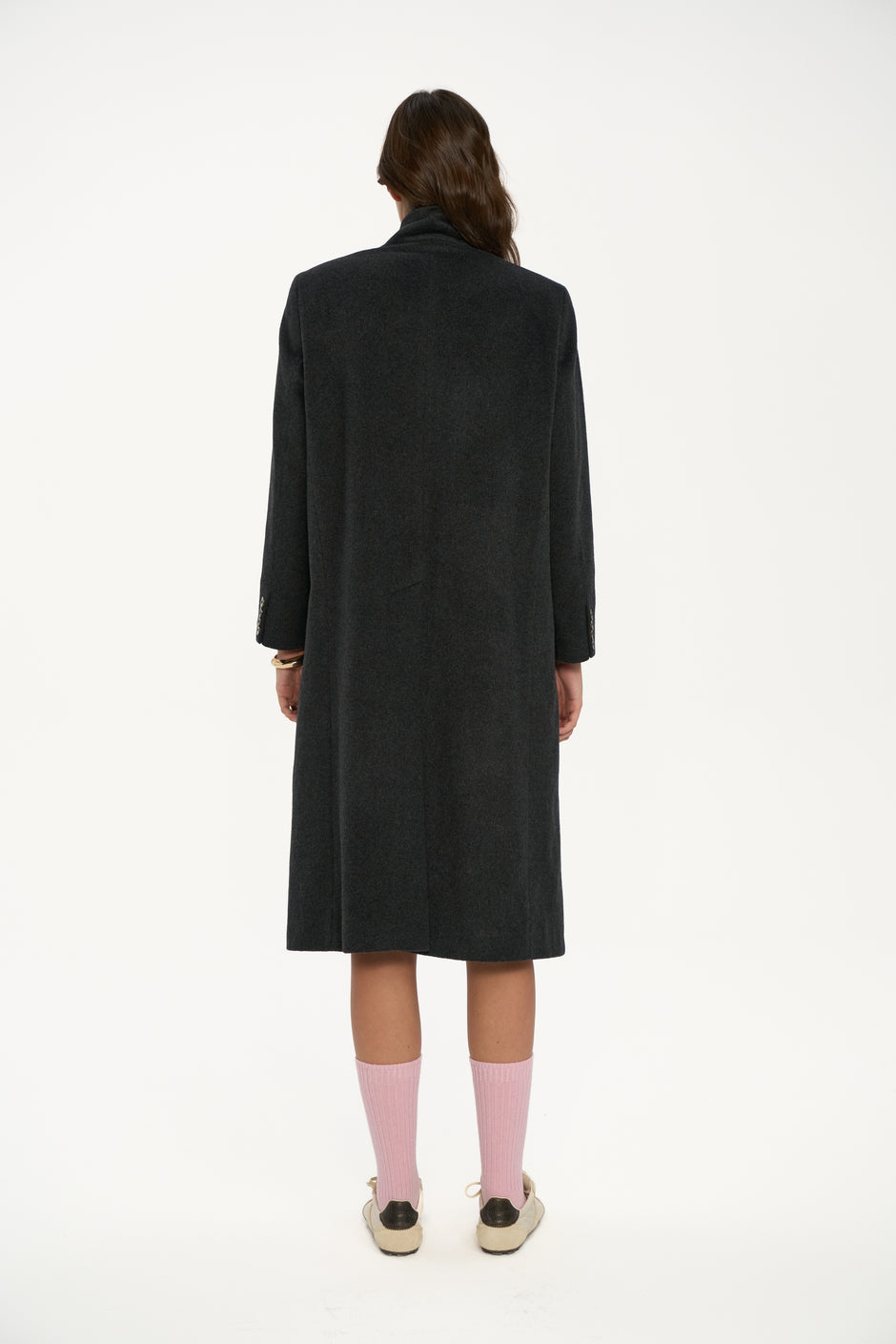 Person wearing a black coat on a white background