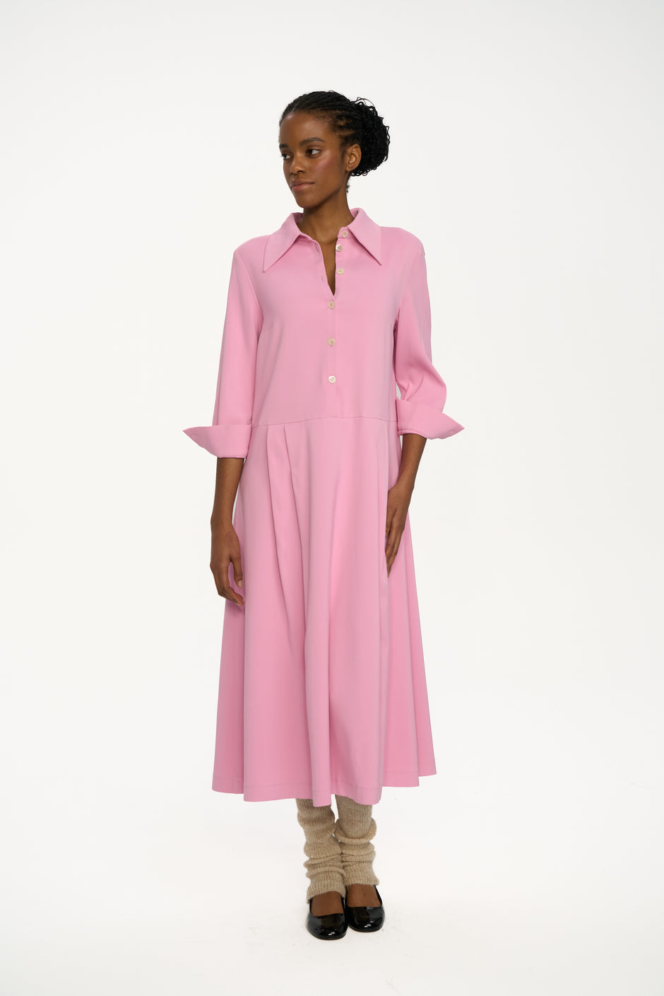 Woman wearing a pink dress on a white background