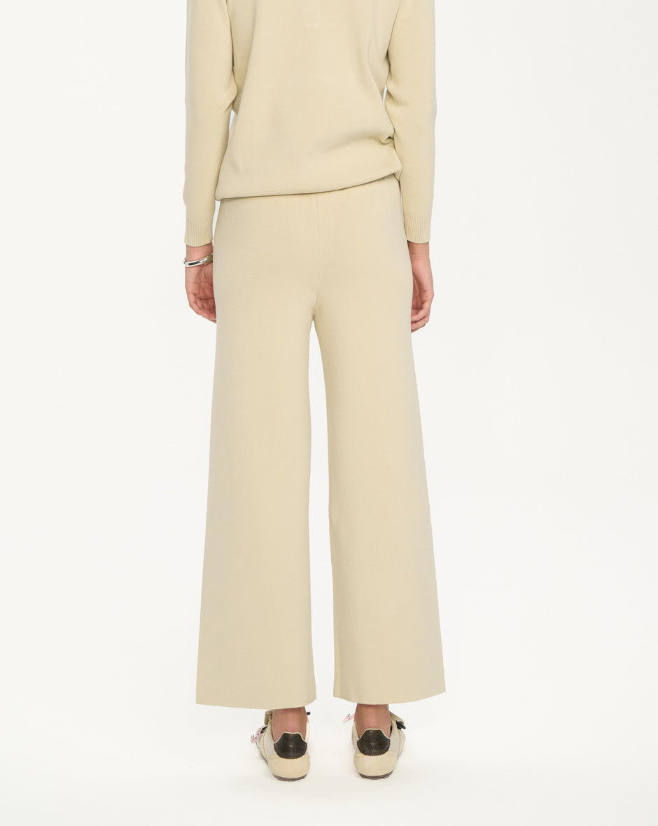 Beige knit polo and wide-leg trousers set on model, full length background view – Inner Tiger
