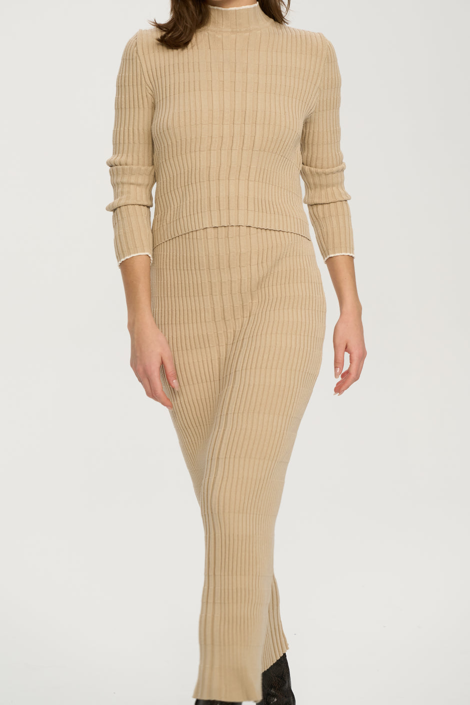 Beige ribbed knit dress on a plain background
