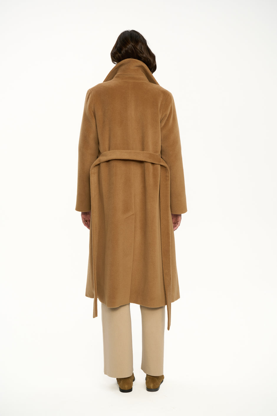 Back view of camel wool wrap coat with belt styled over beige wide-leg trousers – Inner Tiger