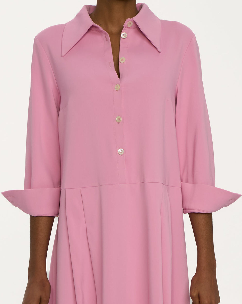 Person wearing a pink dress on a white background