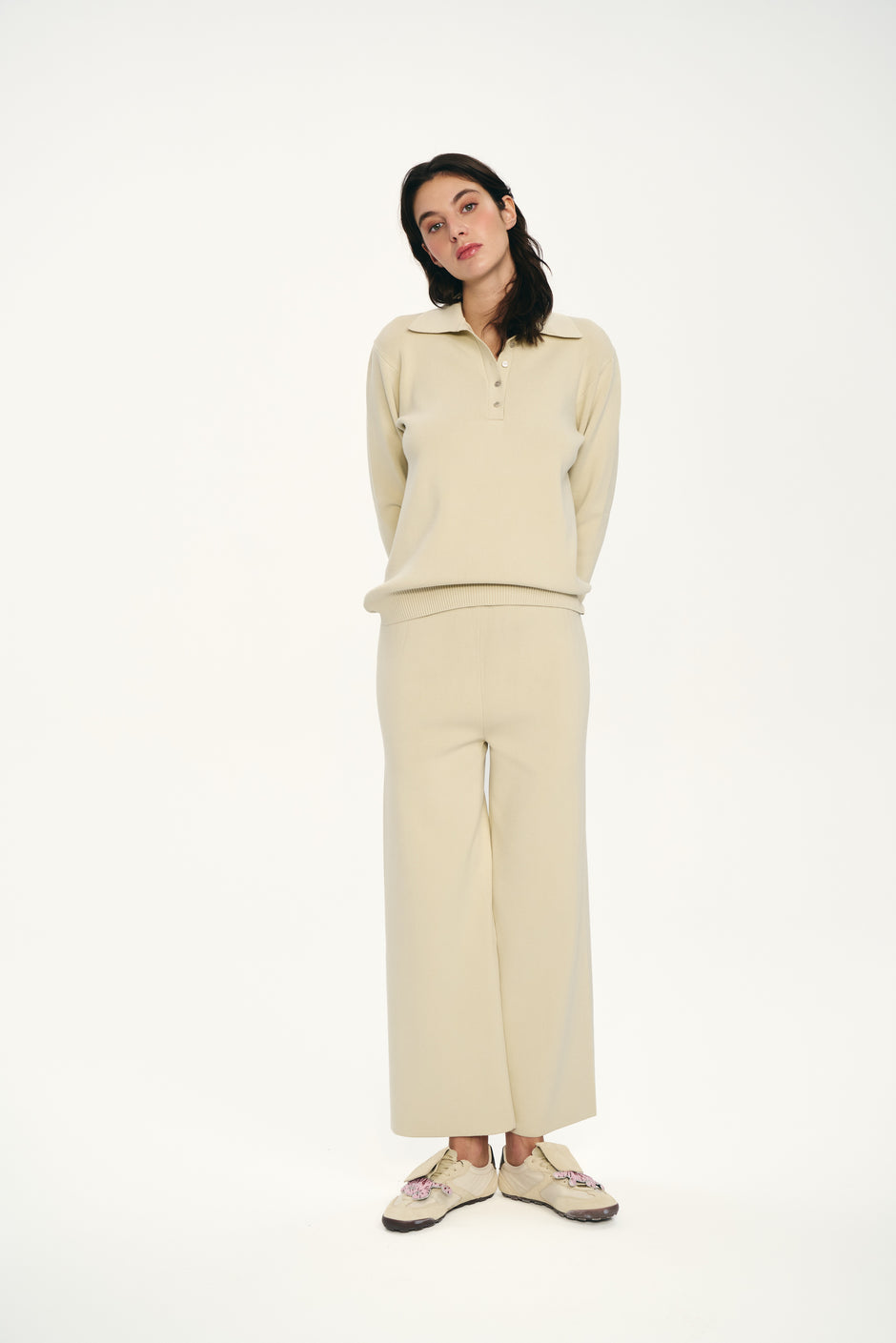 Woman wearing a beige outfit on a white background