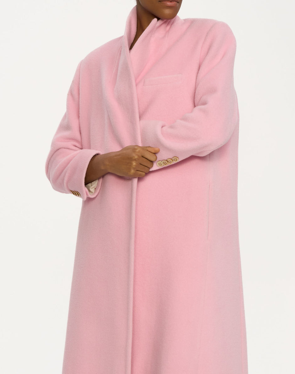 Person wearing a pink wool coat with a white background _ Inner Tiger
